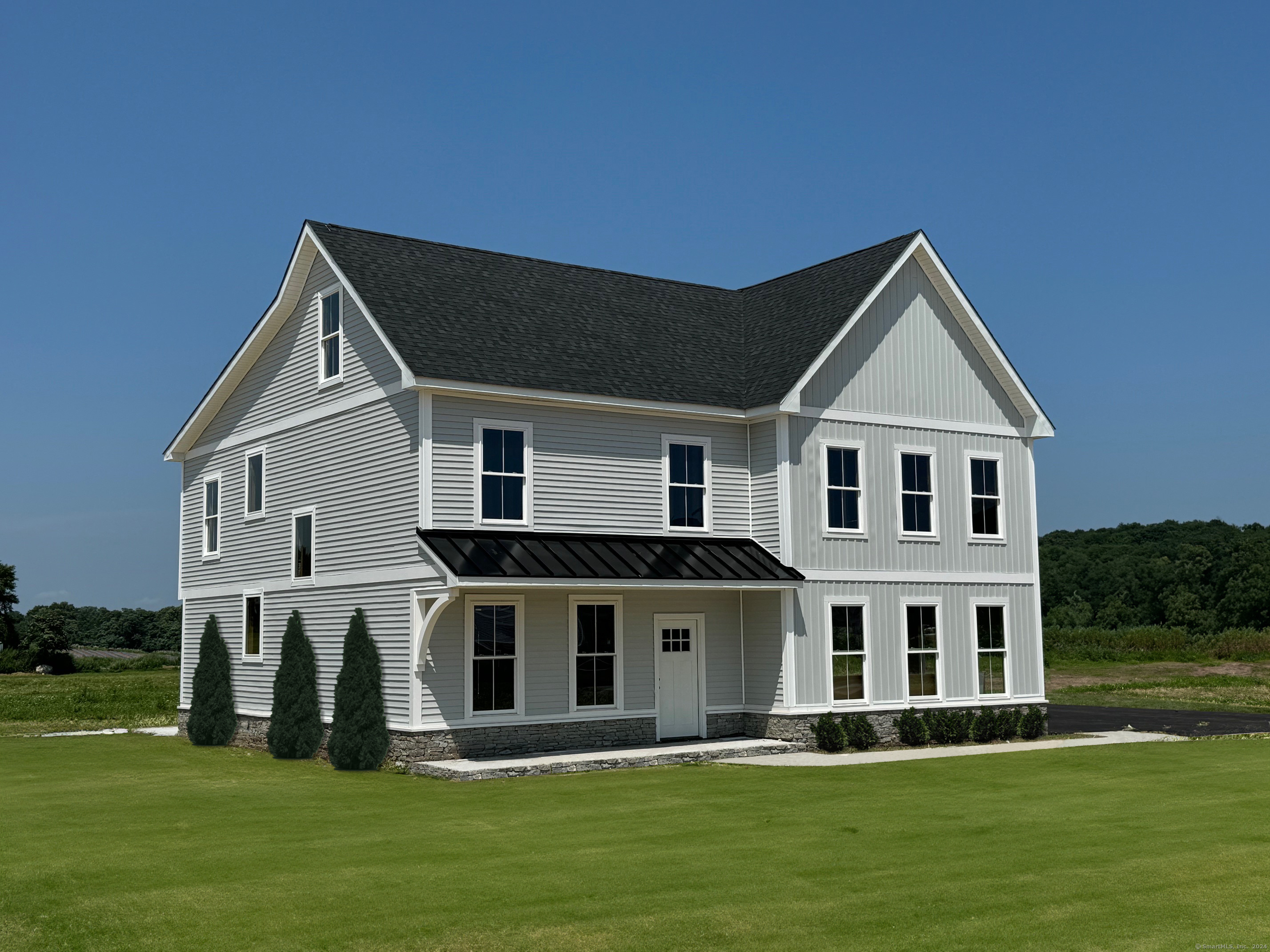 a front view of a house with a garden