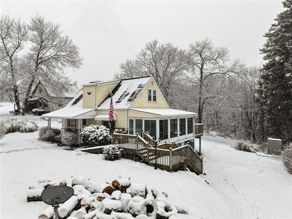 a front view of a house with a yard covered in snow