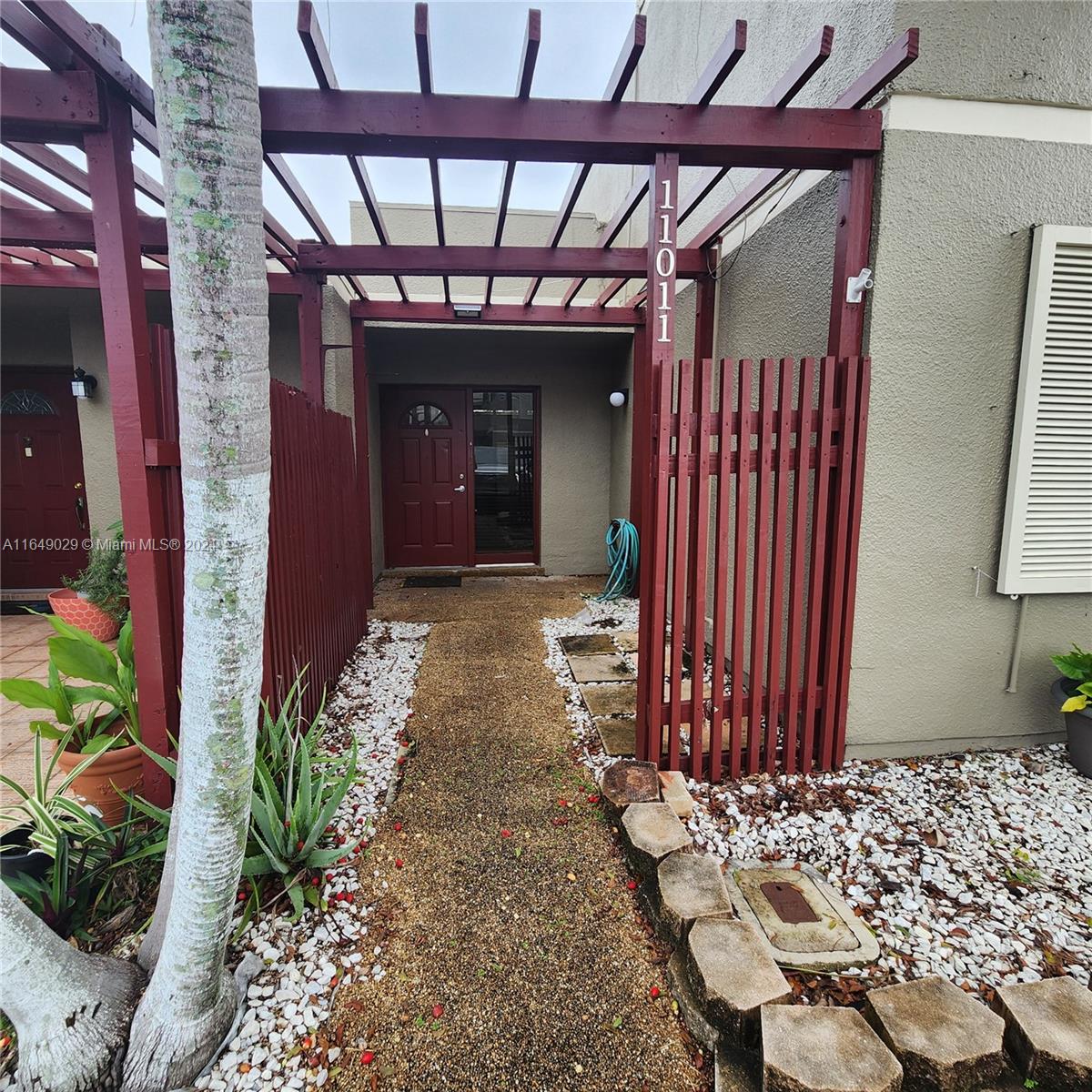 a view of a porch with a table and chairs and potted plants