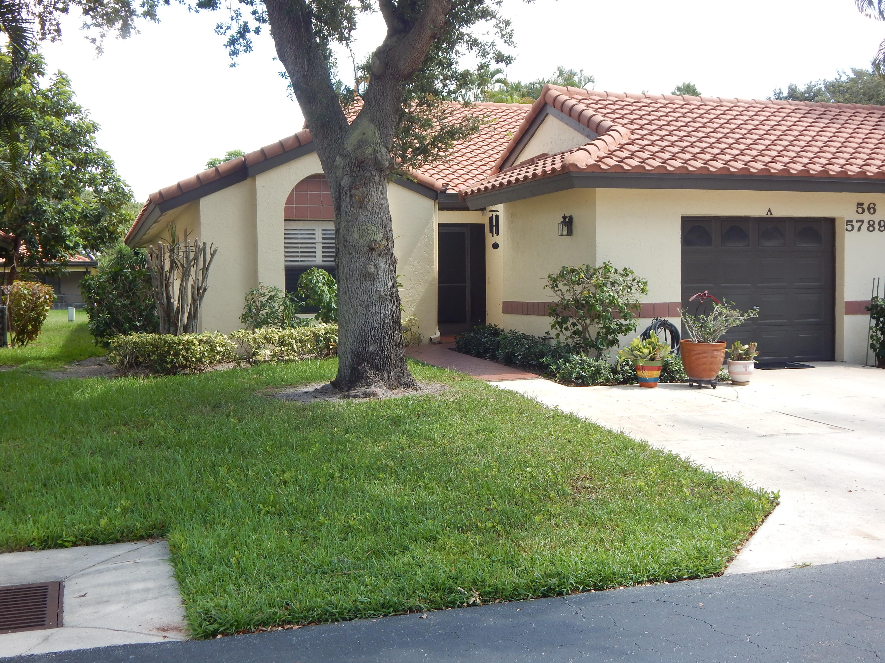 a front view of a house with a garden and yard