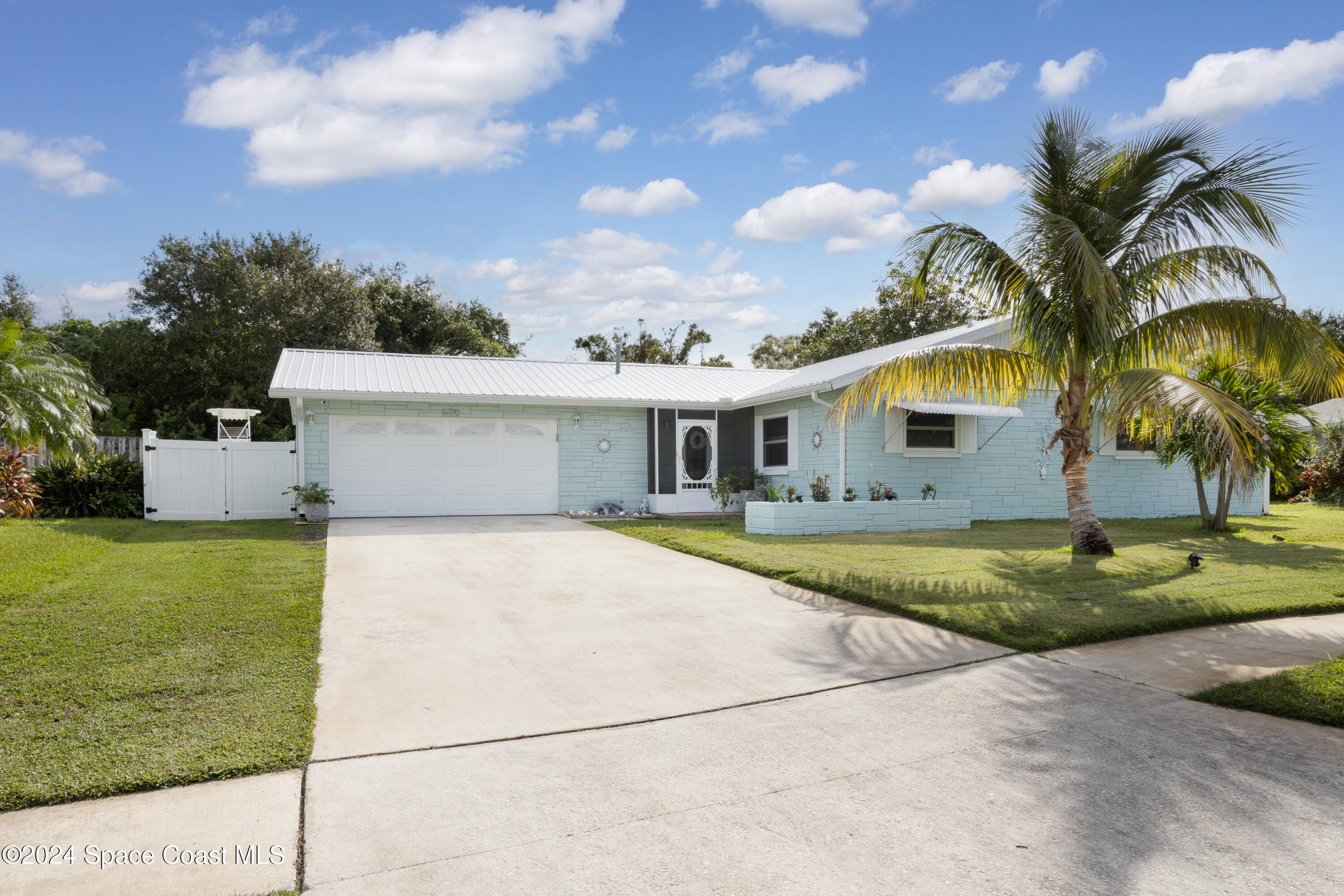 a front view of house with yard and trees