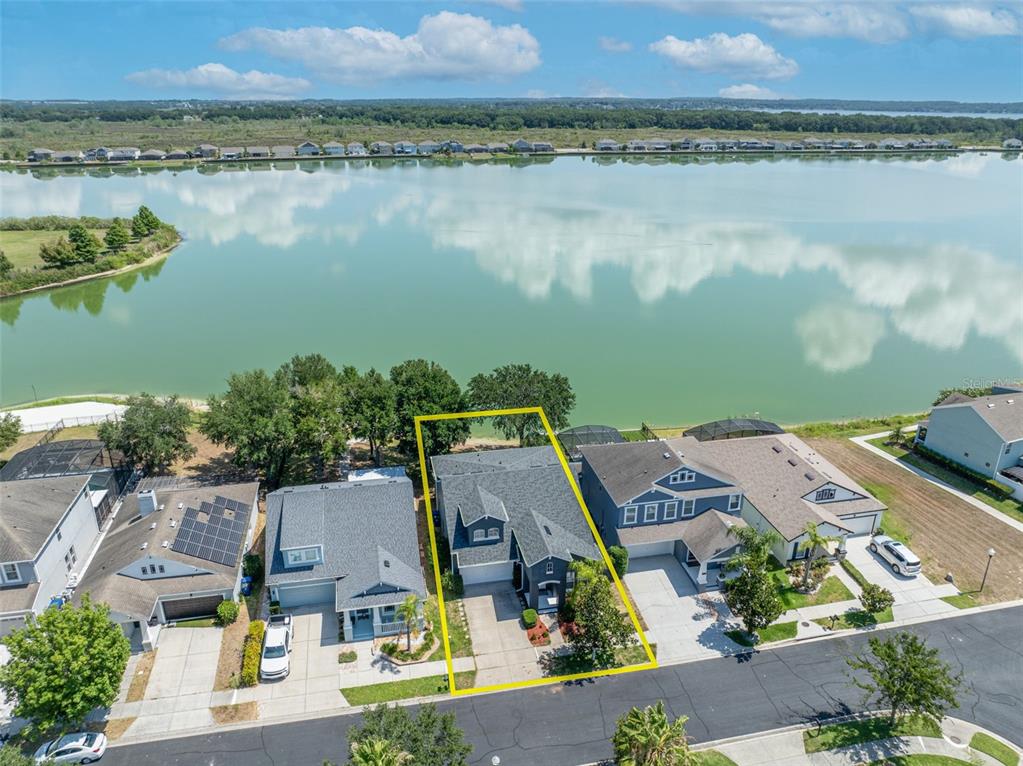 an aerial view of a house with a lake view