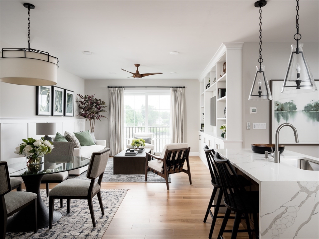 a view of a a dining room with furniture window and wooden floor