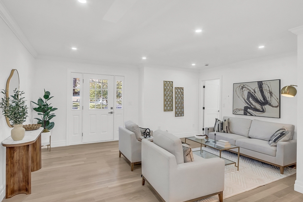 a living room with furniture and a potted plant