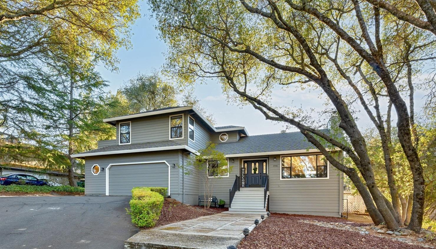 a front view of a house with a garden