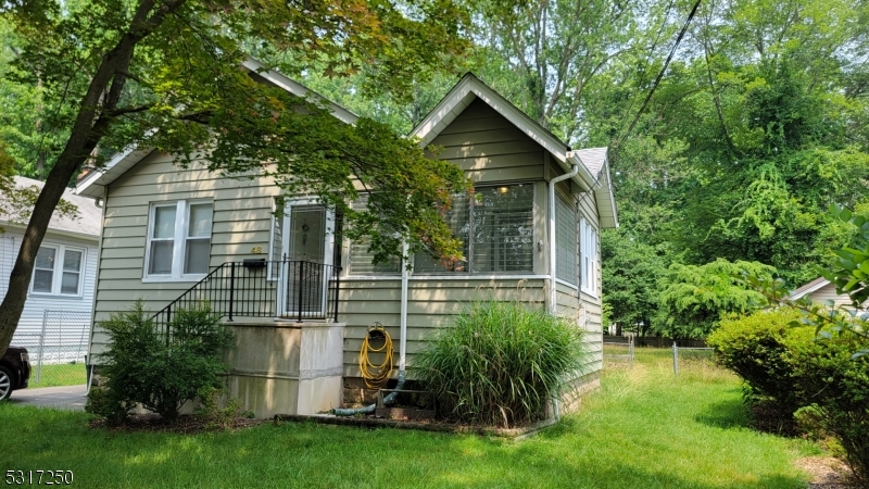 a view of backyard of house with green space