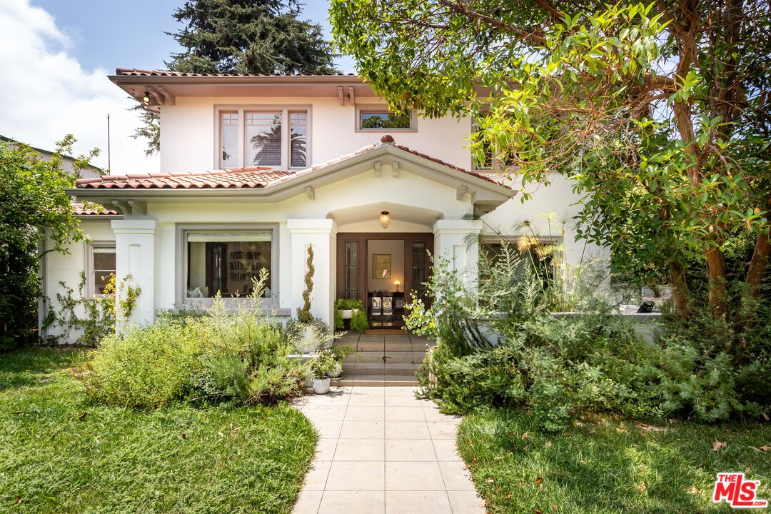 a front view of a house with garden