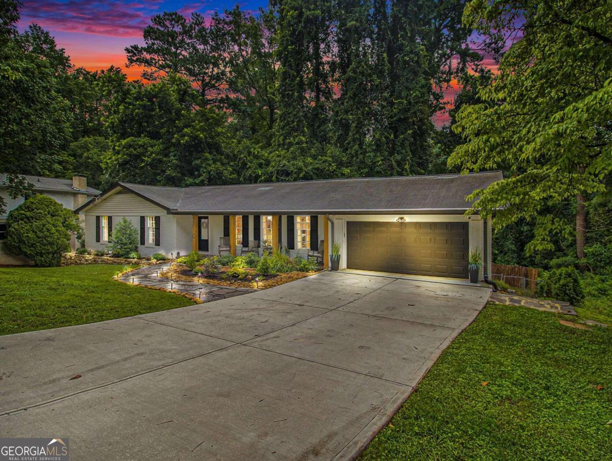 a front view of house with yard and green space