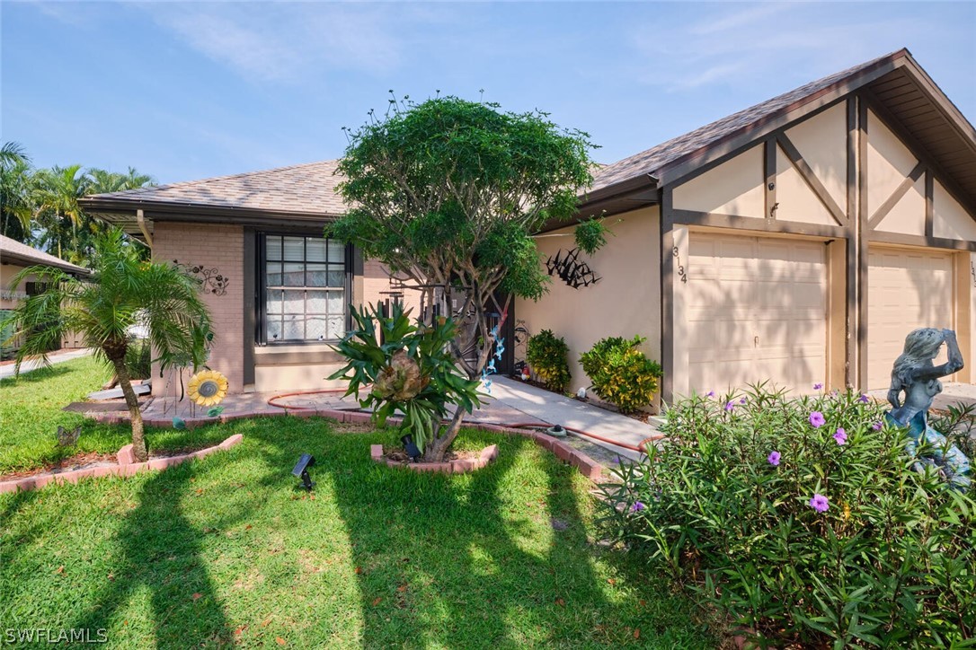 a view of a house with a yard and plants