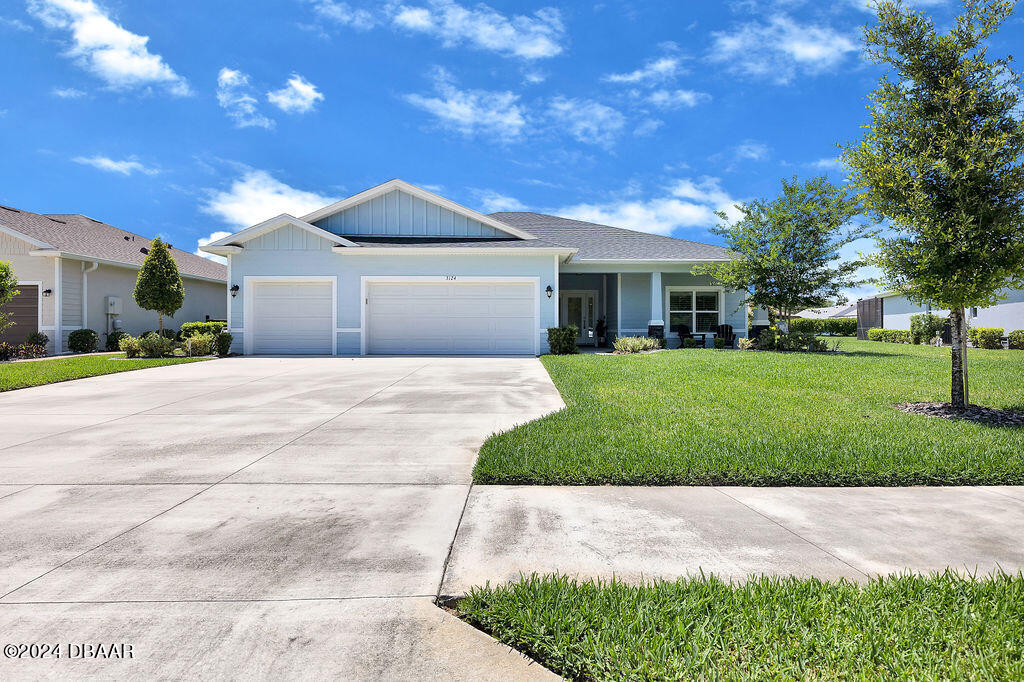 a front view of house with yard and green space