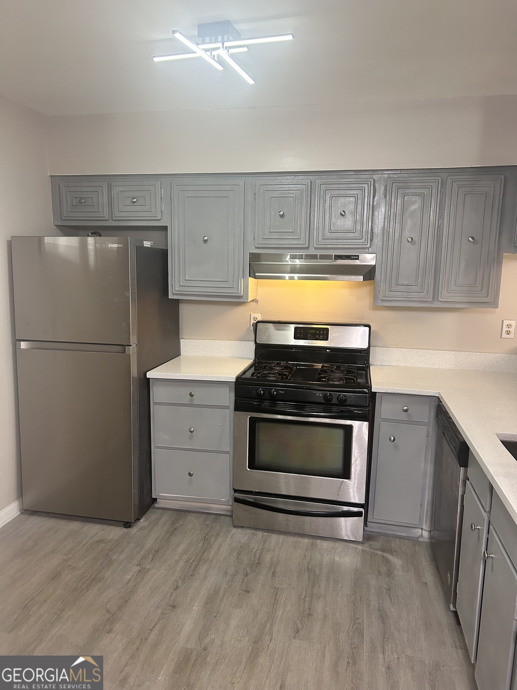 a kitchen with appliances and cabinets