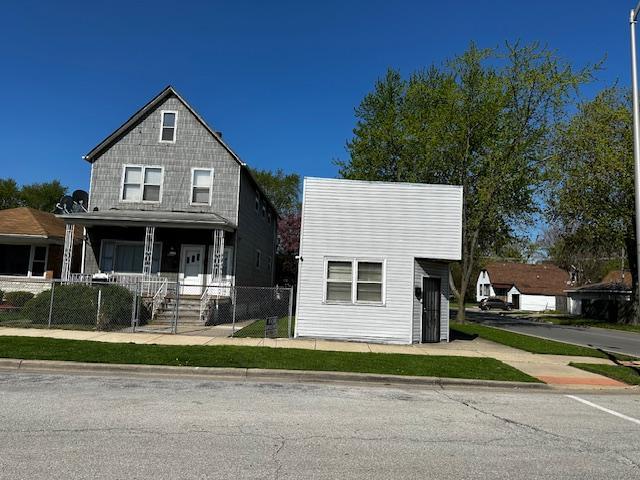 a view of house with outdoor space and parking around