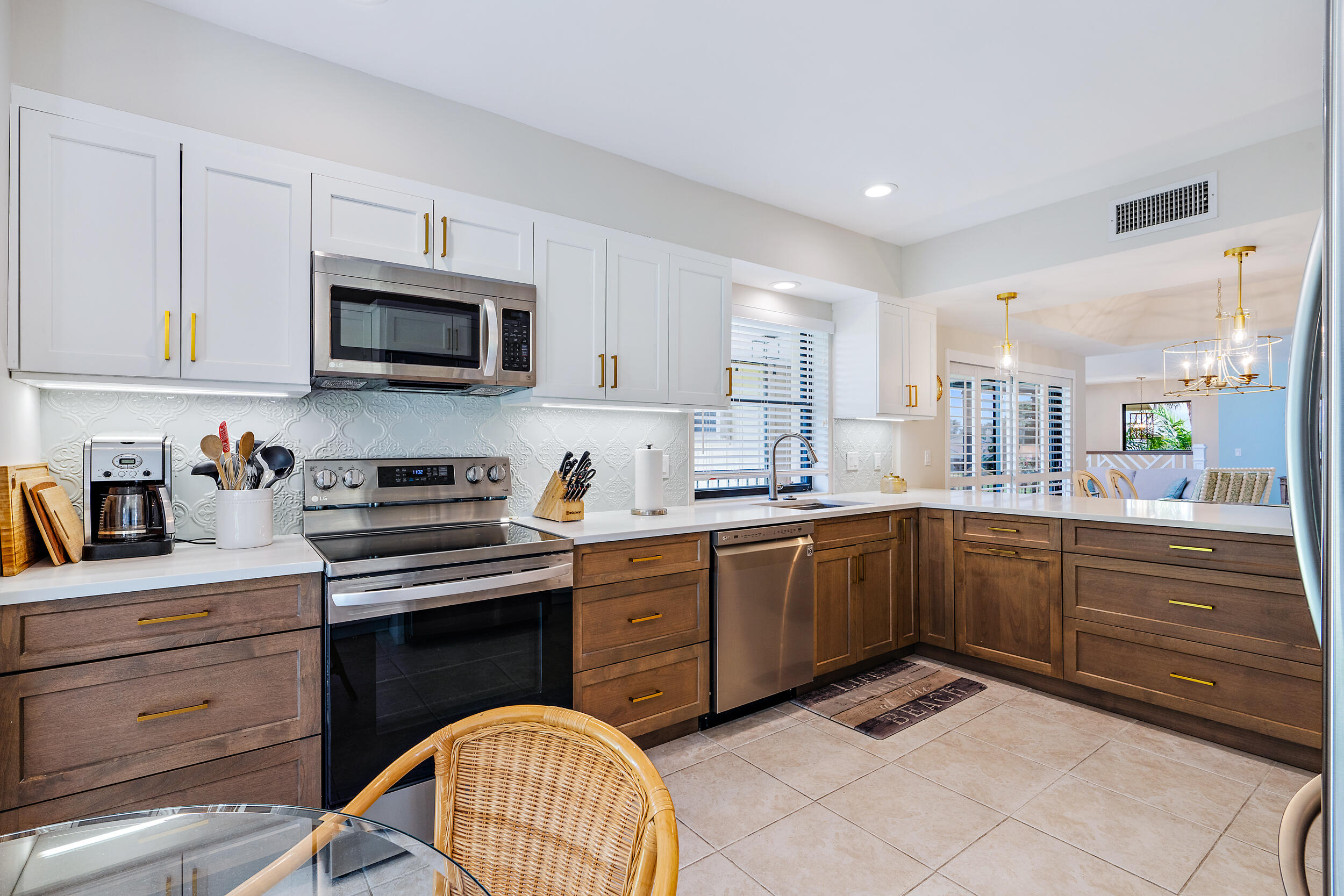 a kitchen with granite countertop cabinets stainless steel appliances and a sink