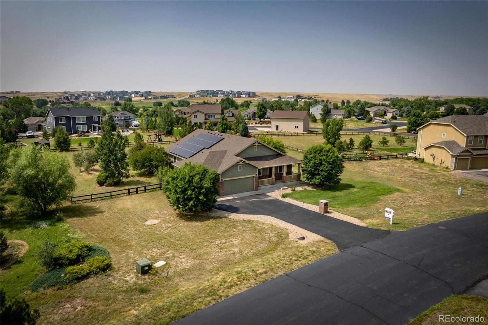 an aerial view of a house with a yard basket ball court and outdoor seating