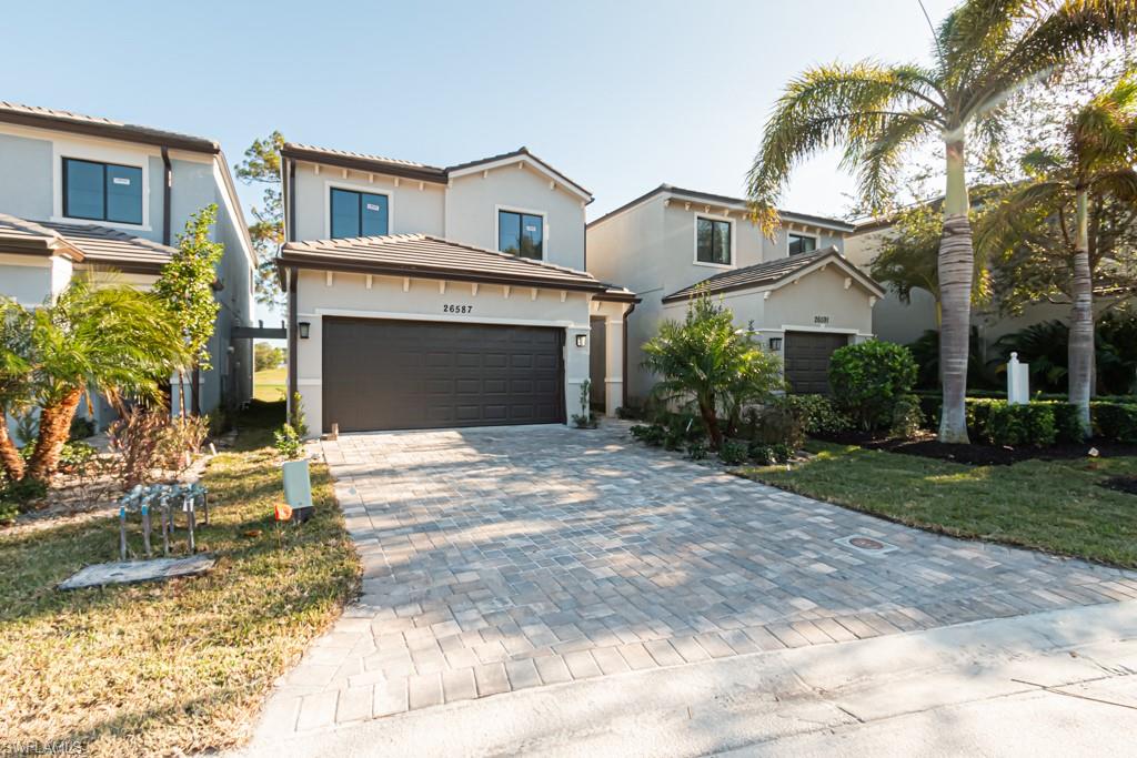 View of front facade with a front yard and a garage