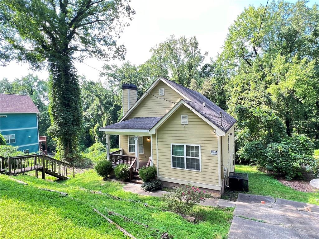 a front view of a house with a yard and porch