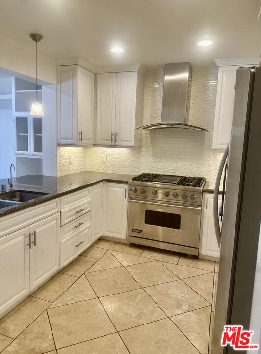 a kitchen with granite countertop white cabinets and appliances