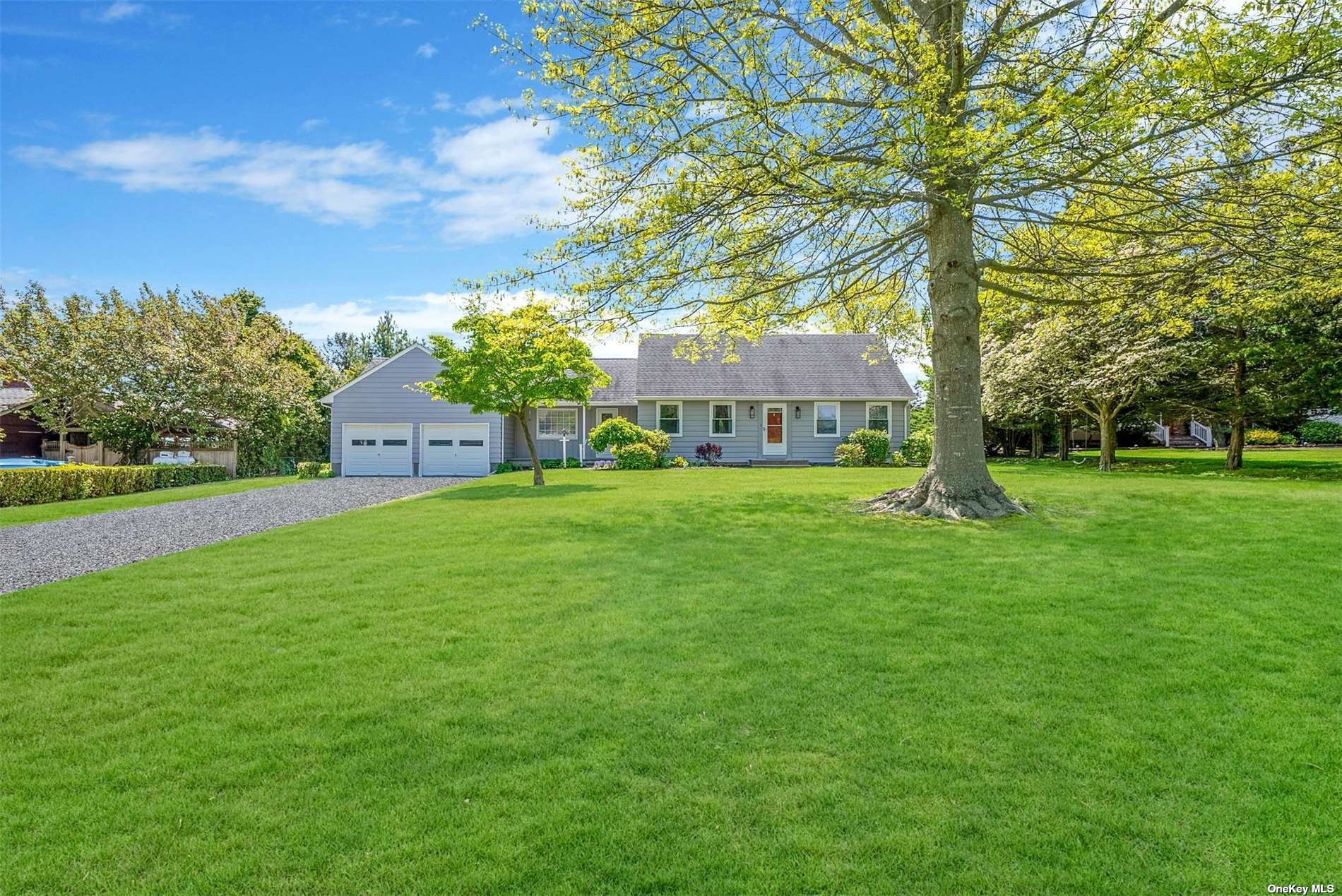 a view of house with a backyard