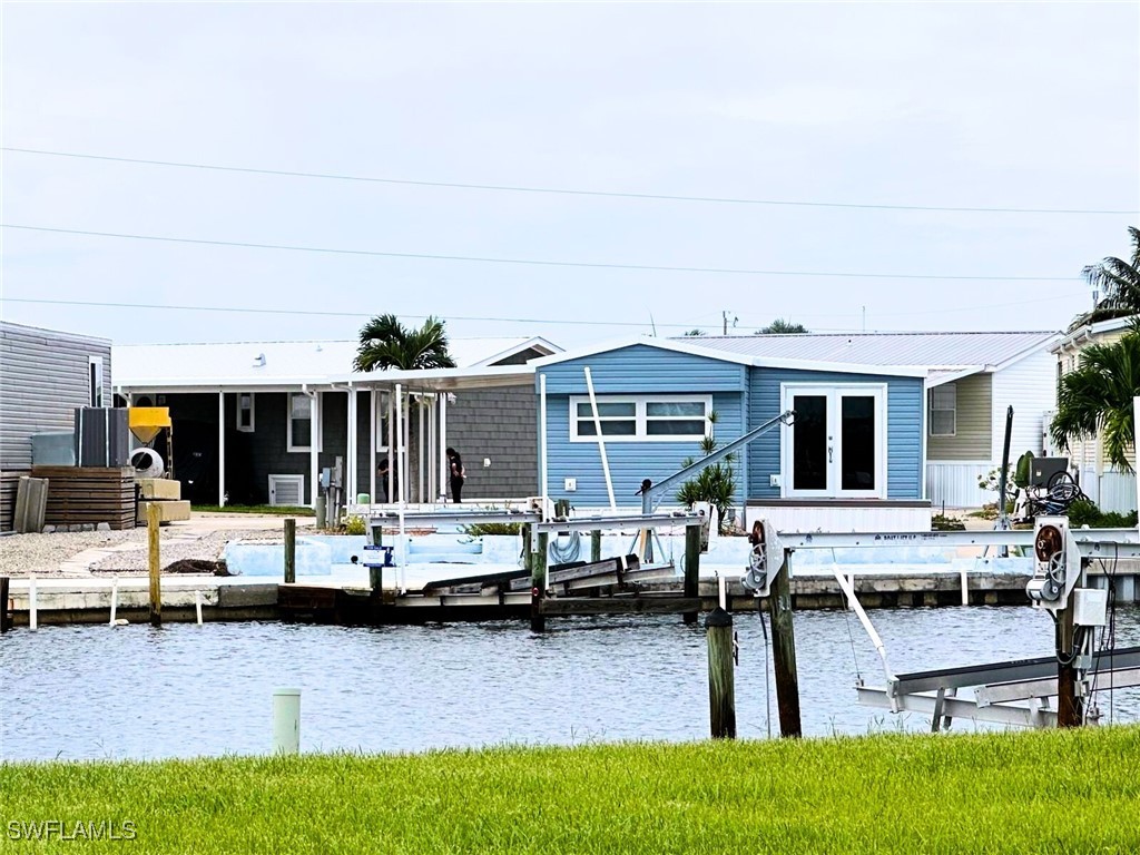 a view of house with yard and sitting area