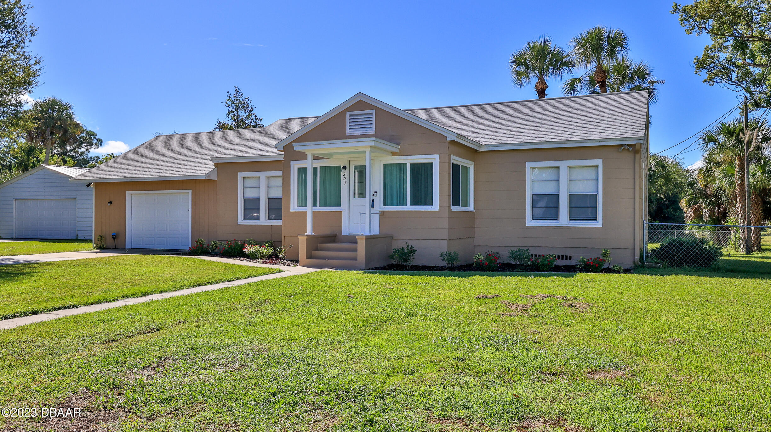 a front view of a house with a garden