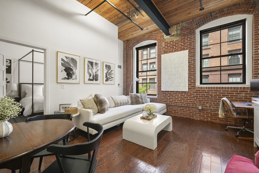 a living room with furniture and wooden floor