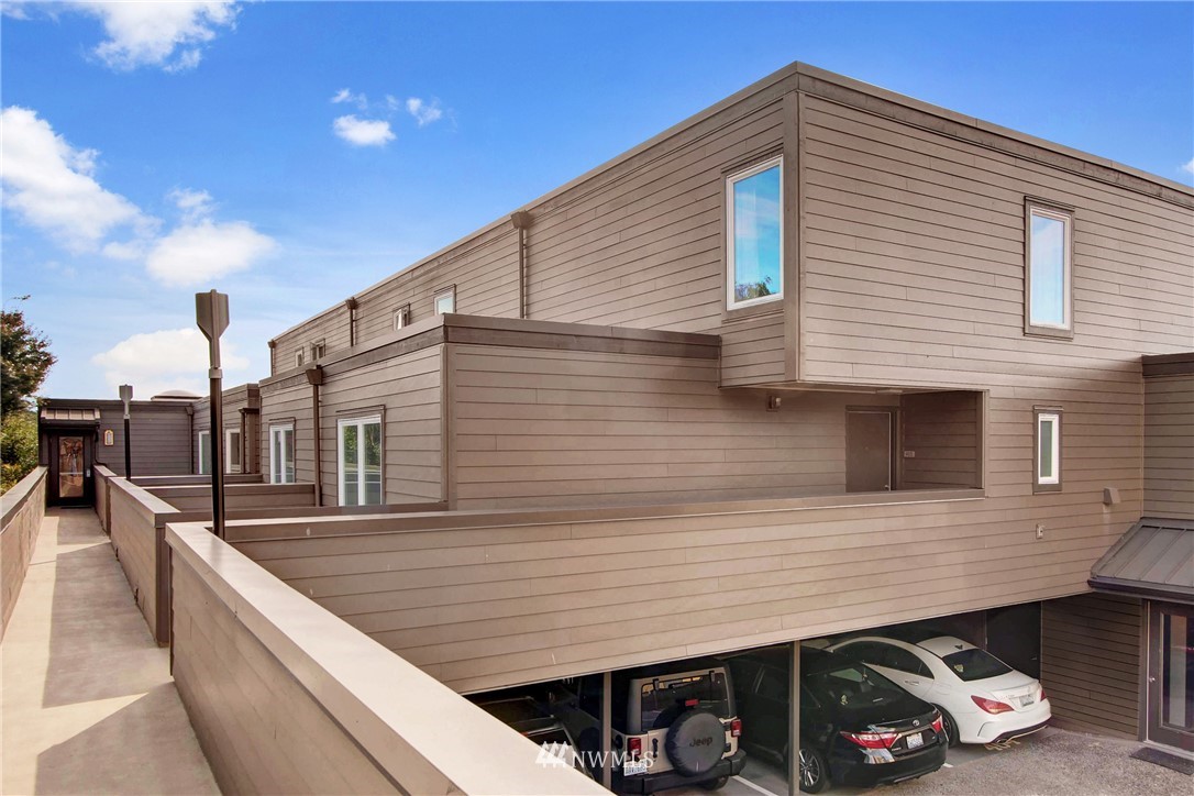 a view of a house with a deck and furniture