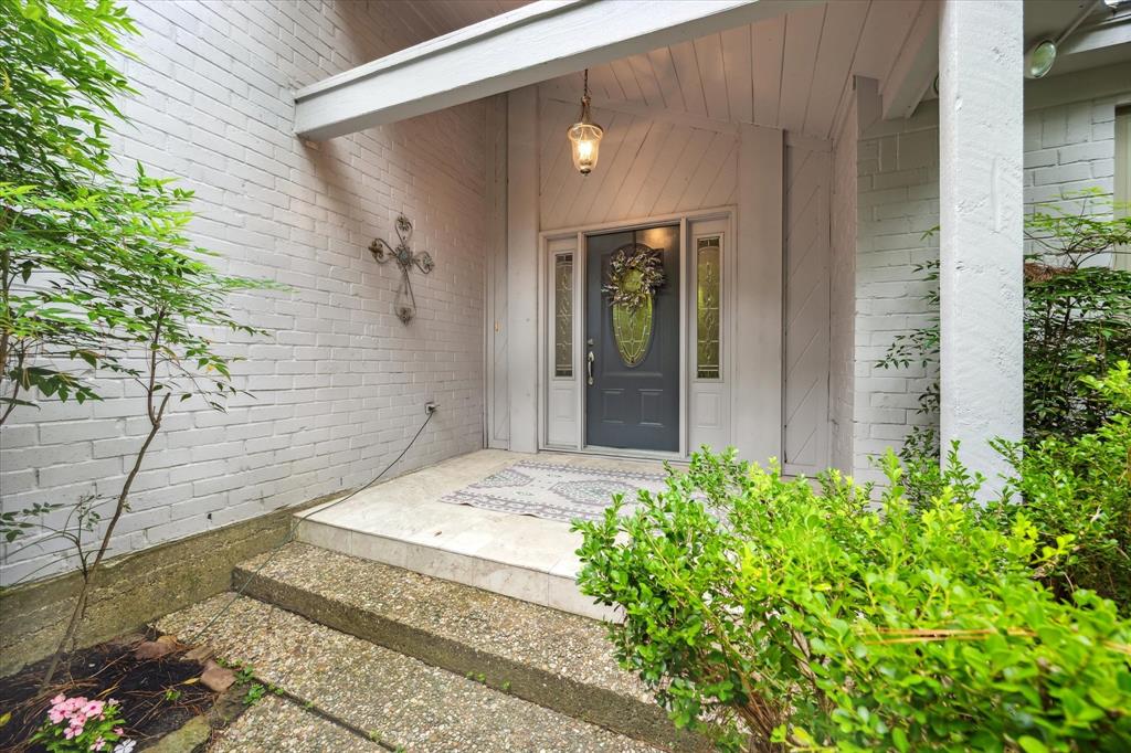 a entryway to a house with potted plants