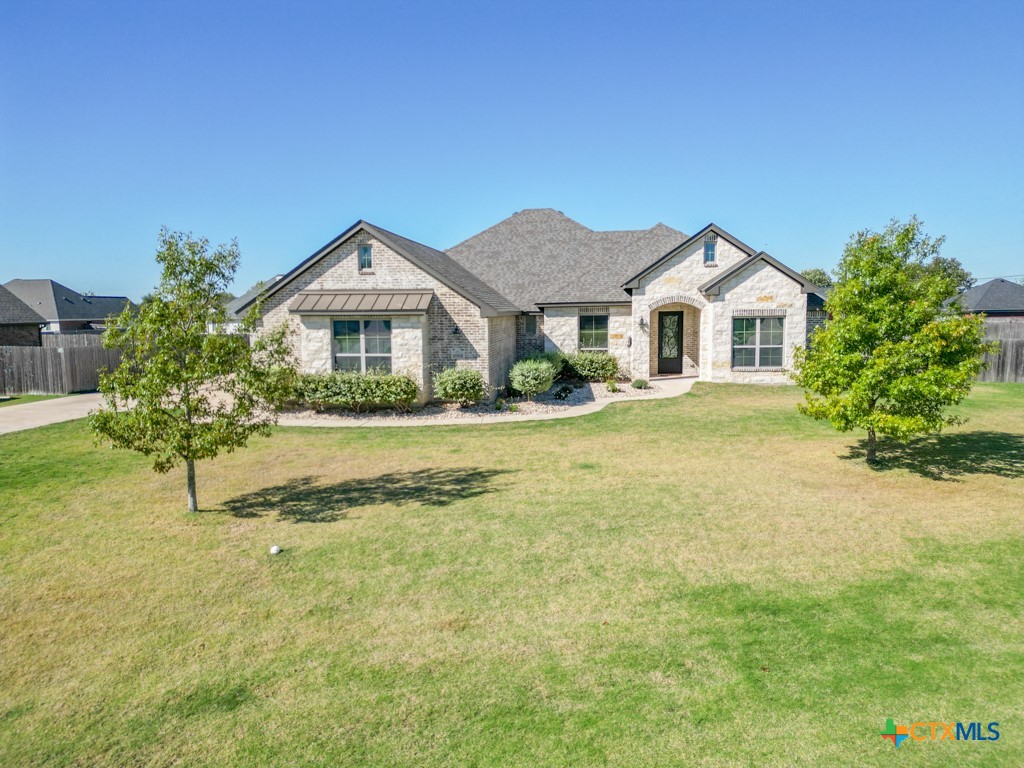 a front view of a house with a yard