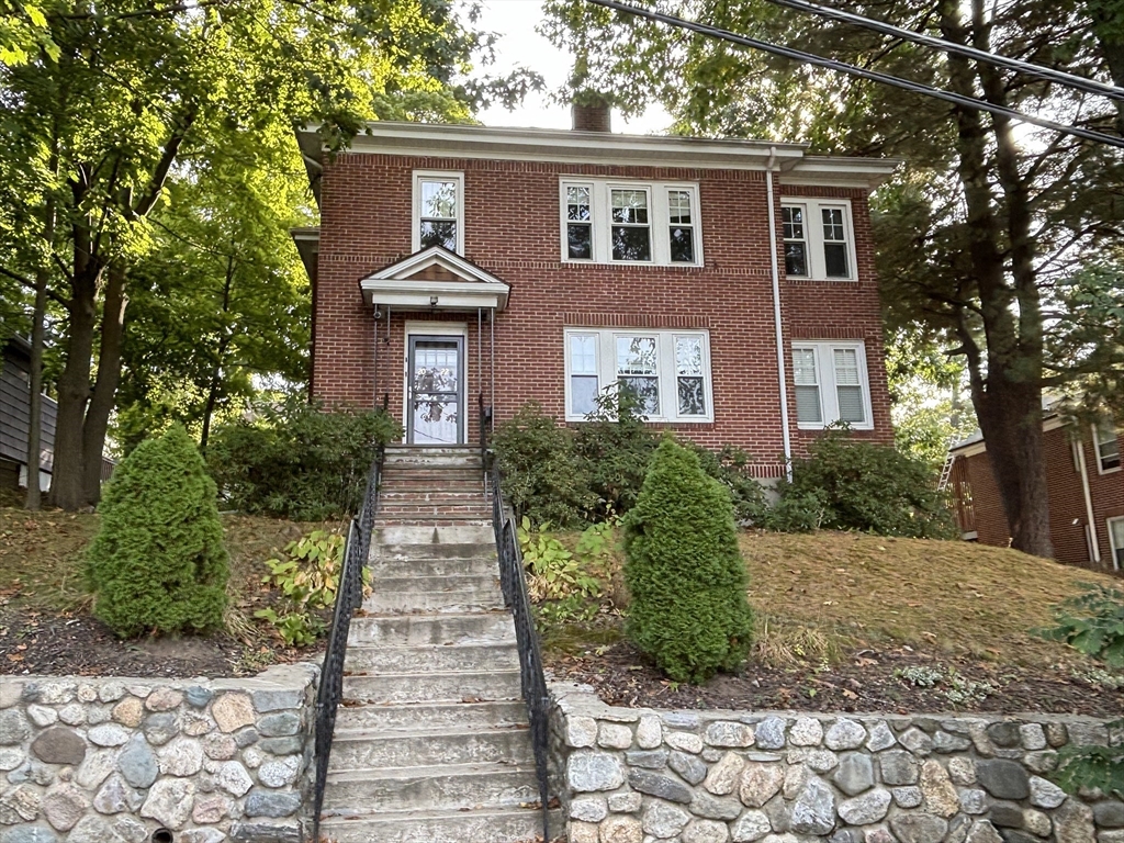 a front view of a house with garden