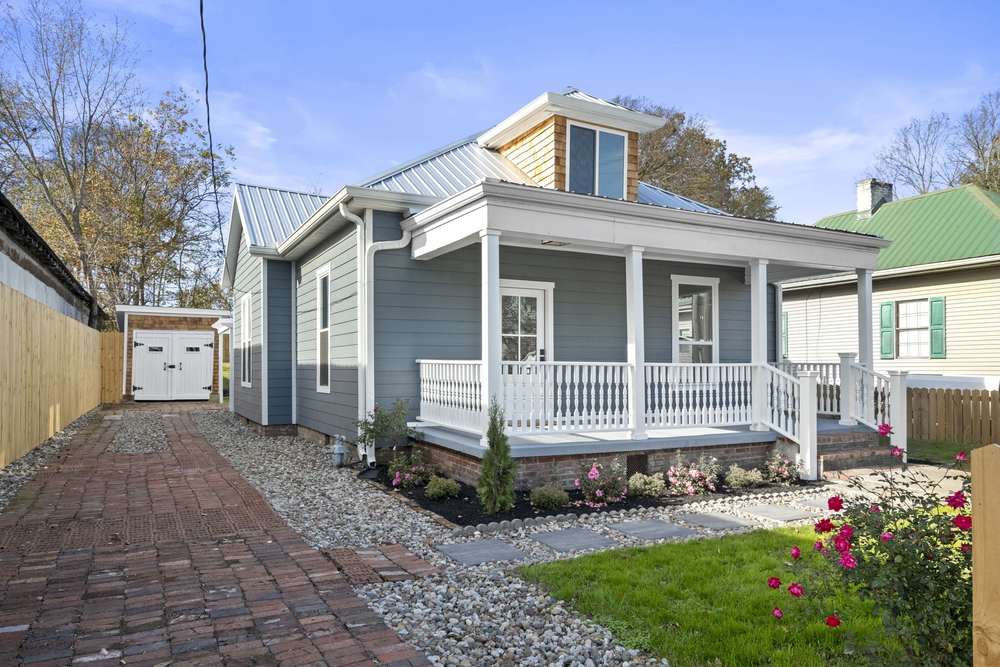 a front view of a house with a yard and outdoor seating