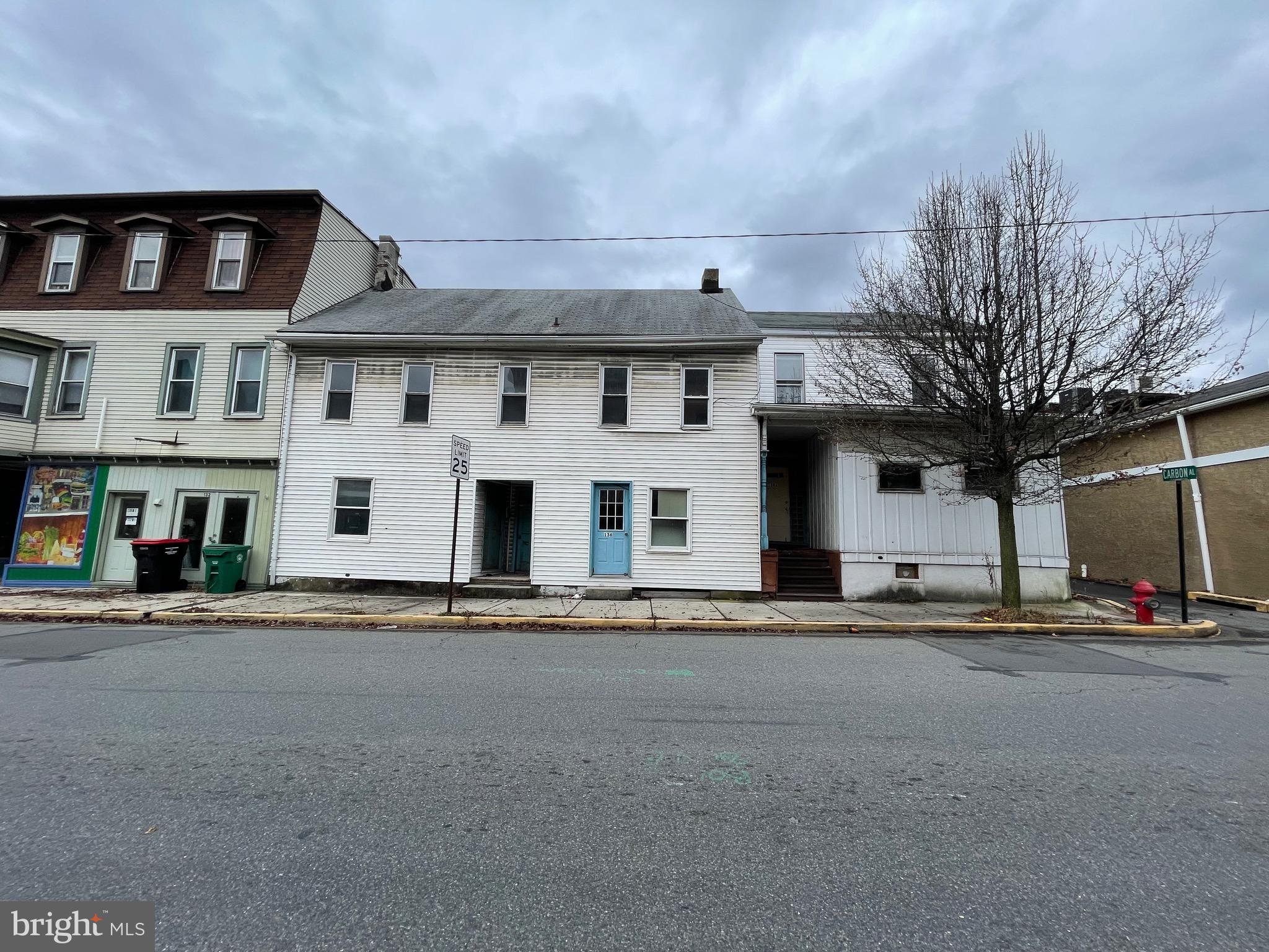 a front view of a building with lot of street