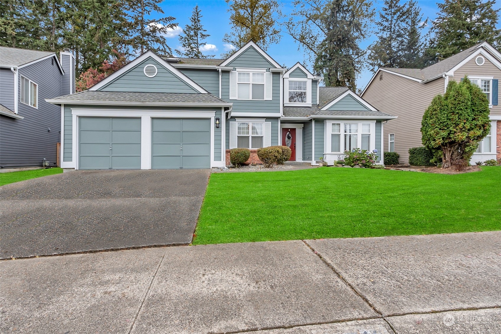 a front view of a house with a yard and garage