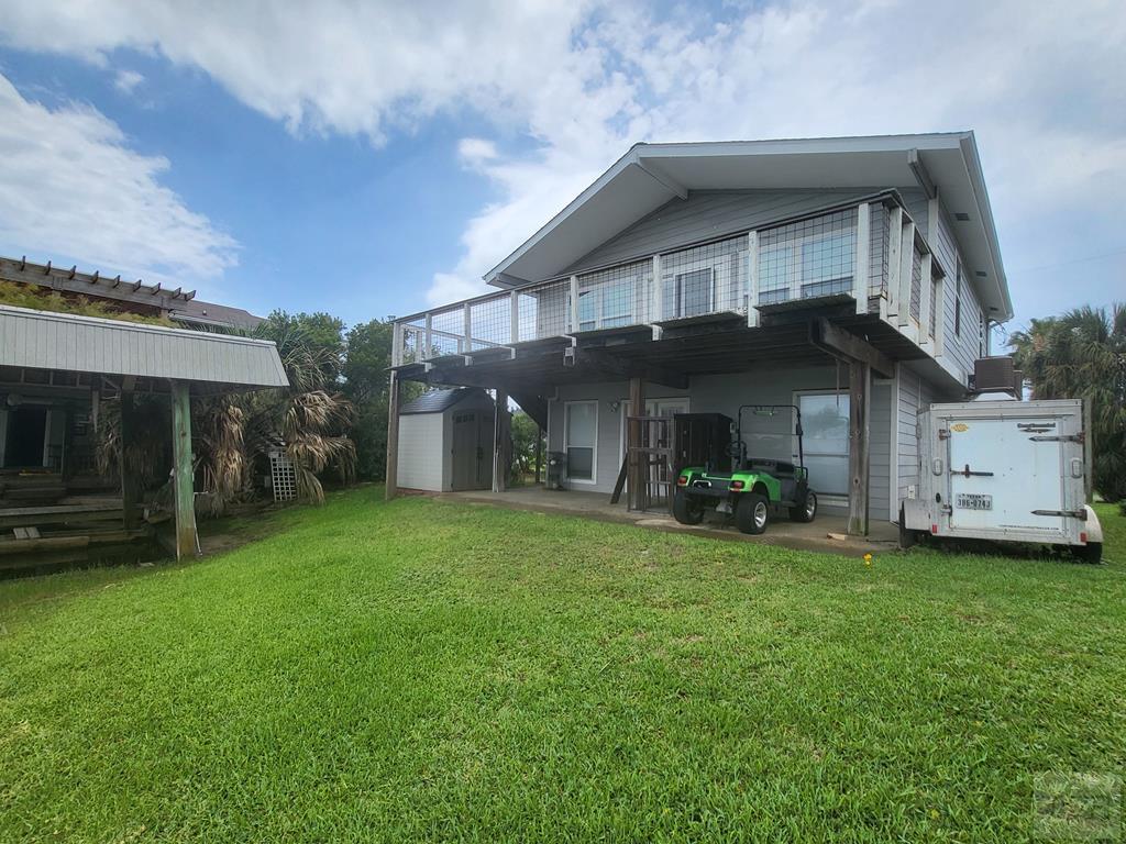 a view of a house with a big yard and large trees