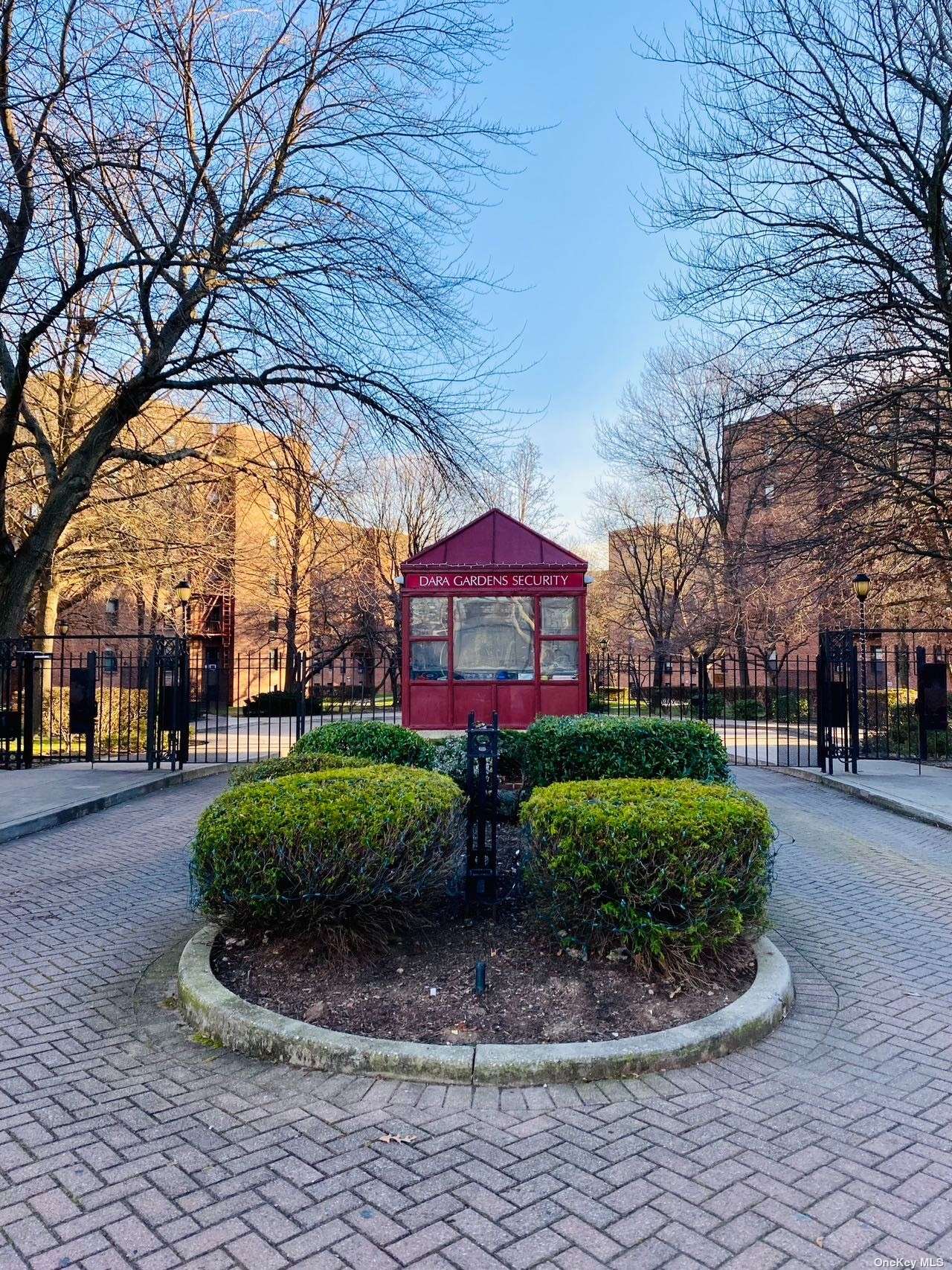 a view of a fountain in front of a brick house