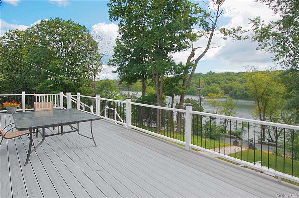 a view of a deck with two chairs and wooden floor