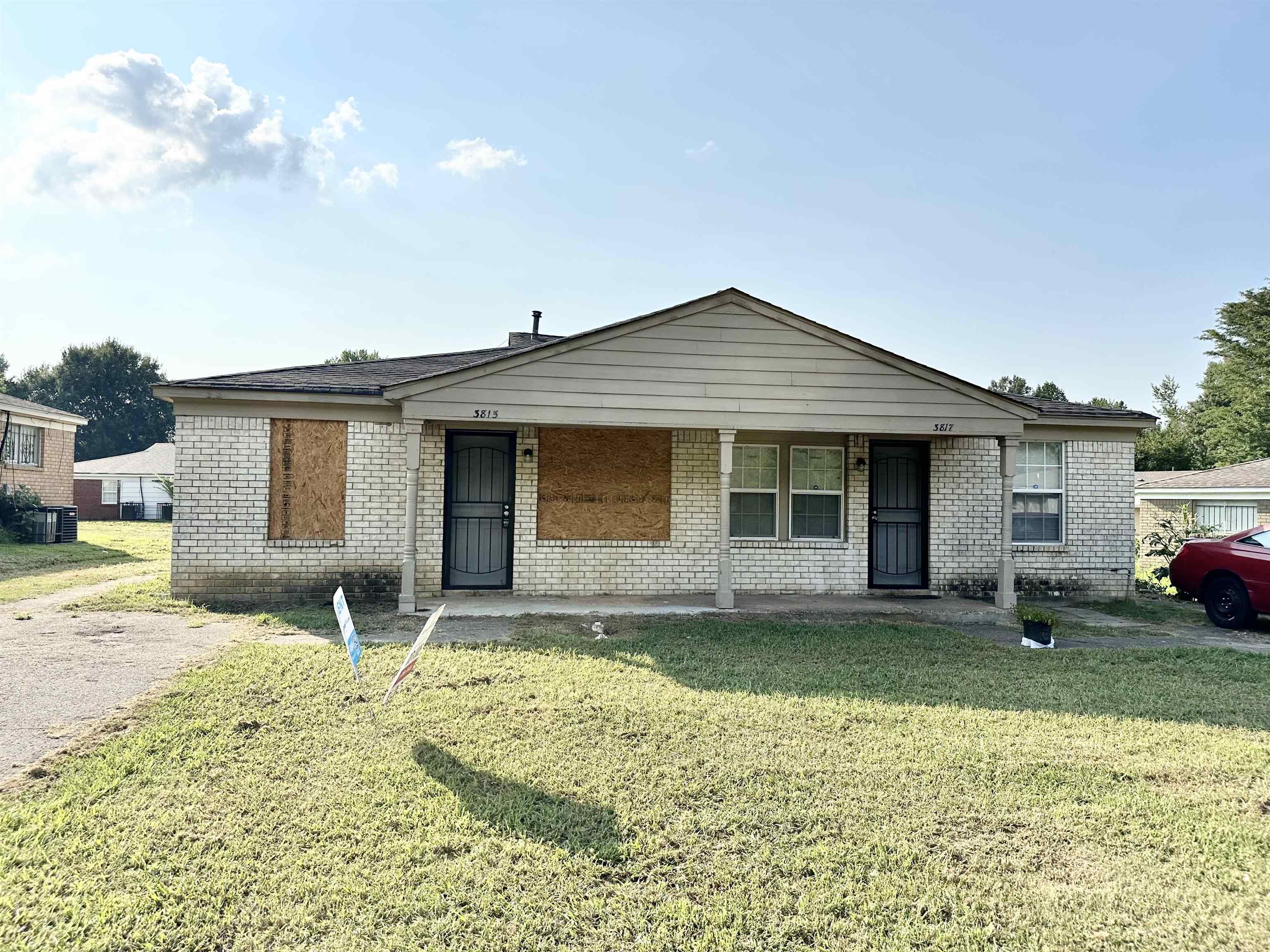 Ranch-style home featuring covered porch and a front yard