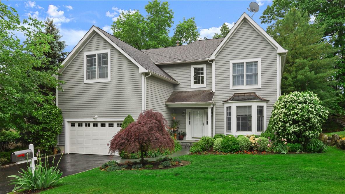 a view of a house with a yard and a garden