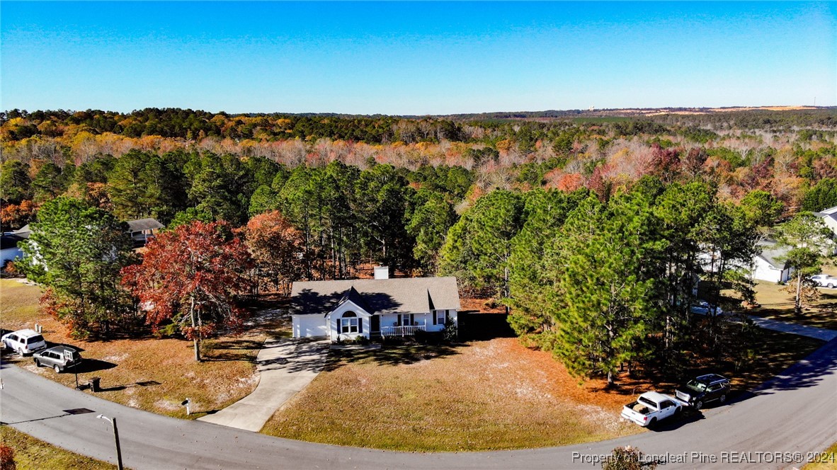 an aerial view of a house with a yard and lake view