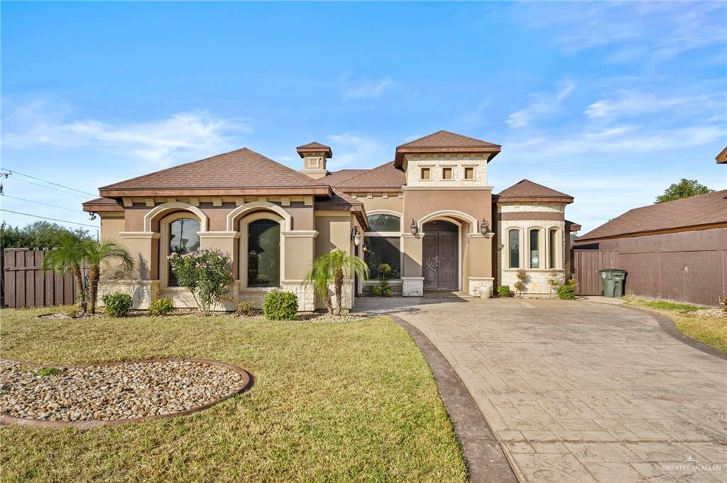 Mediterranean / spanish-style house with a front lawn