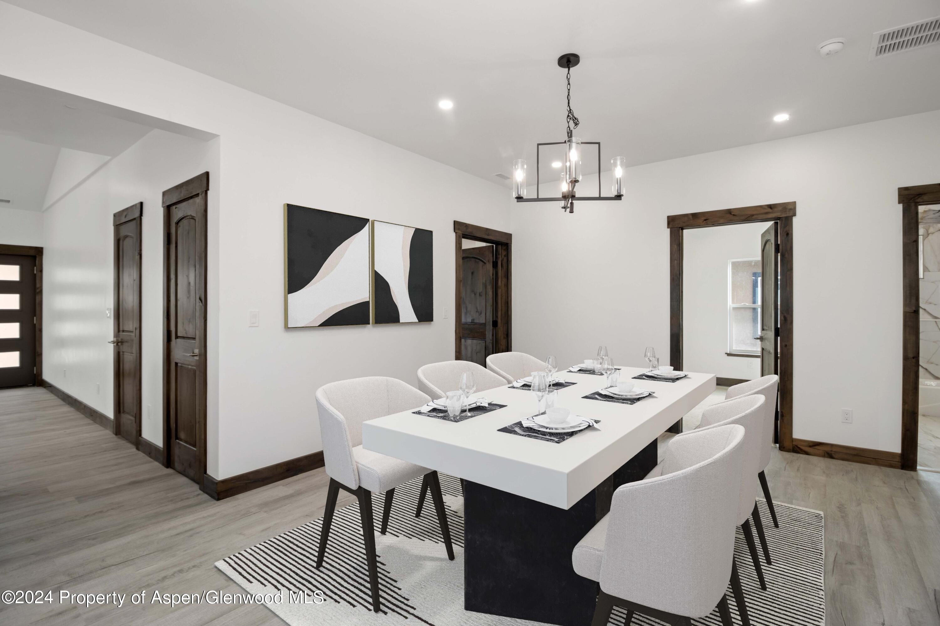 a view of a dining room with furniture wooden floor and chandelier