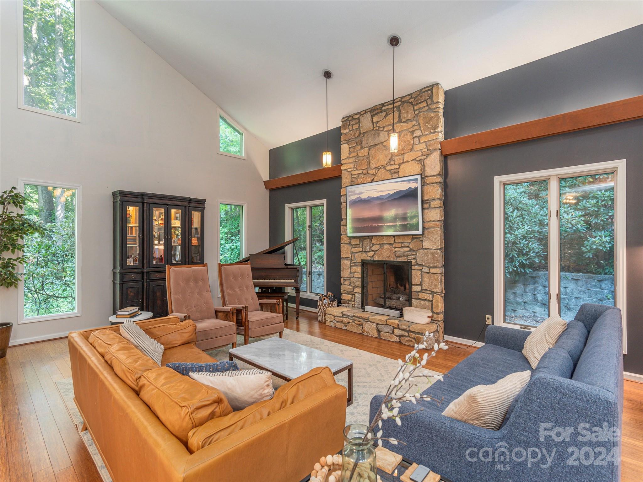 a living room with furniture large window and fireplace