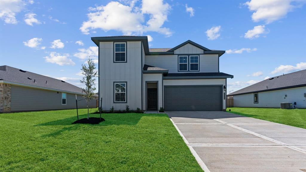 a front view of a house with a yard and garage