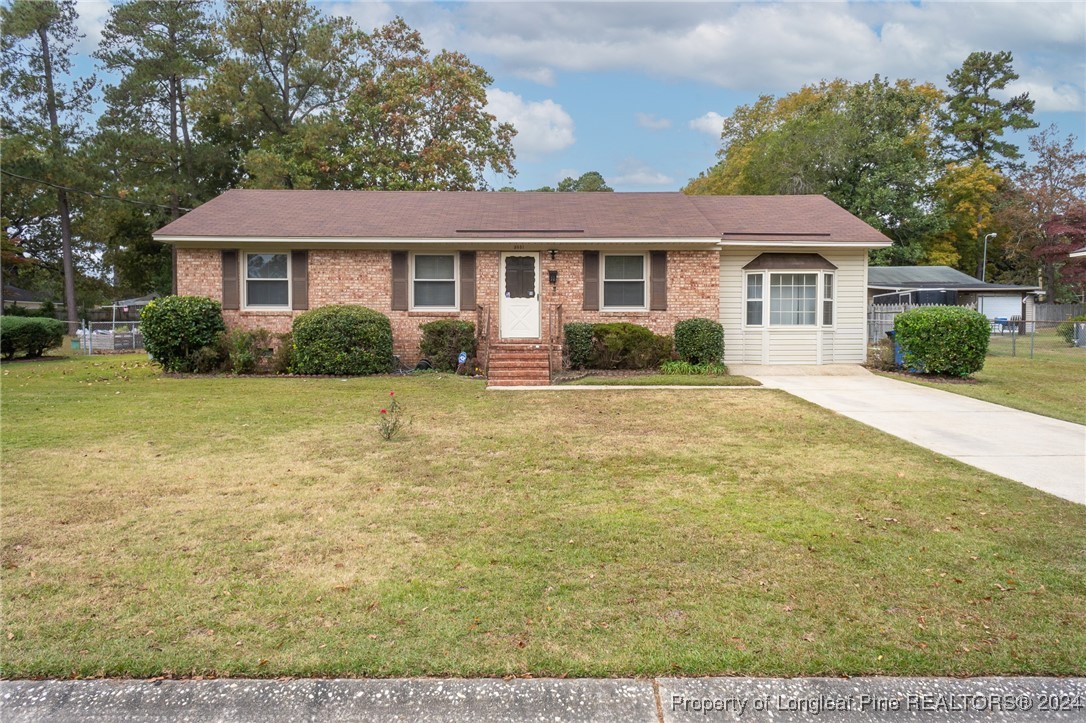 a front view of a house with yard and green space