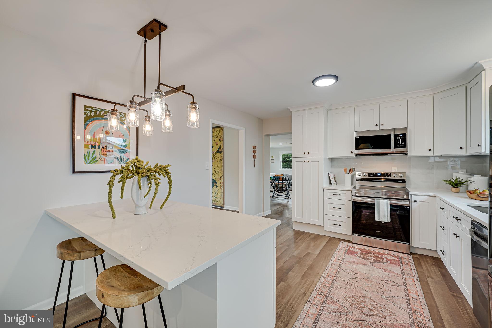 a kitchen with microwave and refrigerator