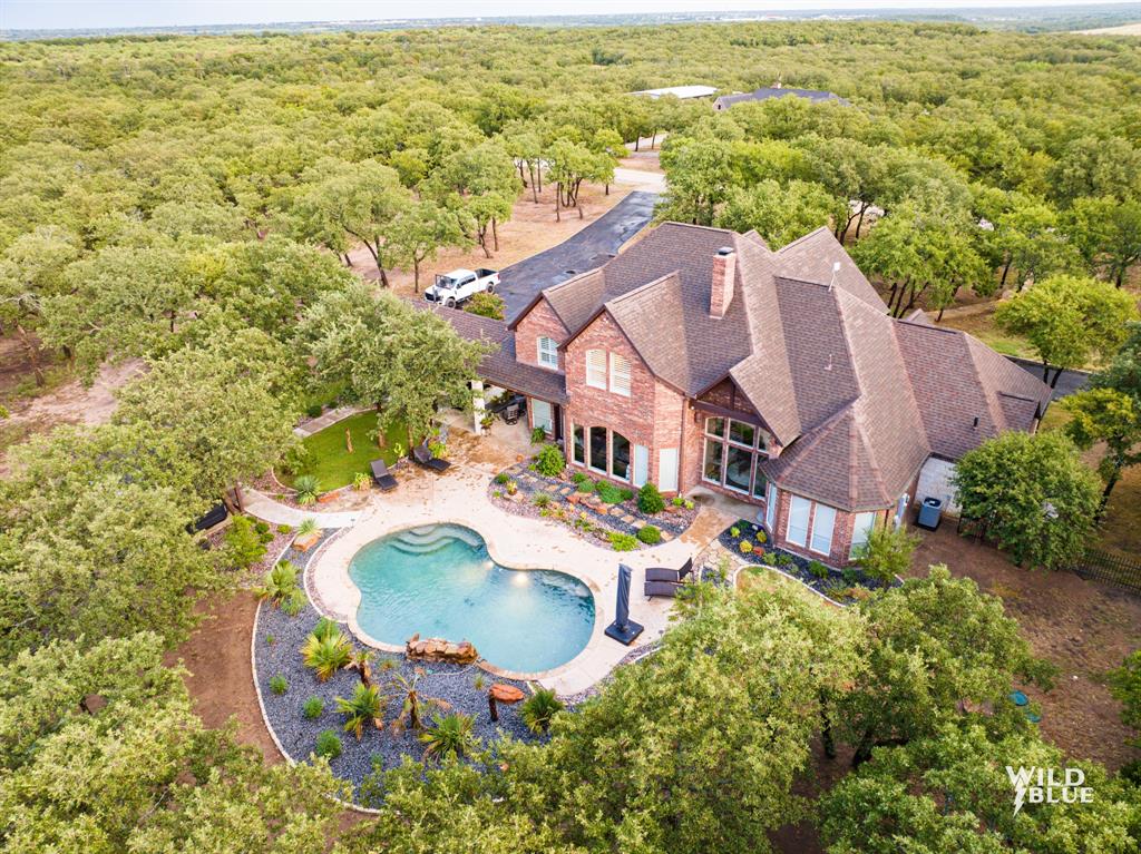 an aerial view of residential house with outdoor space and swimming pool