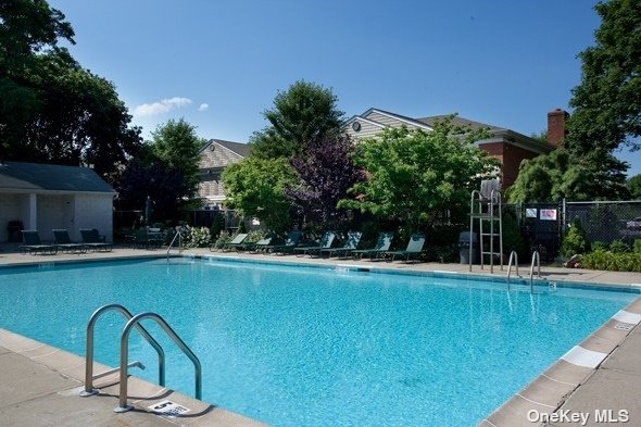 a view of a swimming pool with a table and chairs