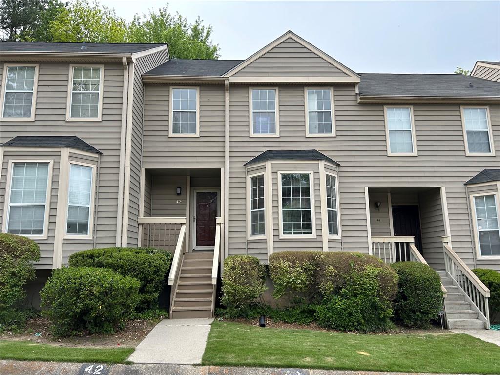 a front view of a house with a yard