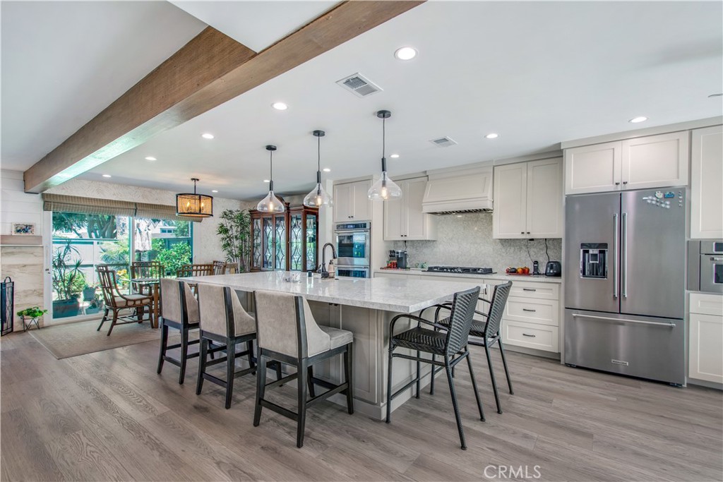 Beautiful open concept kitchen area featuring huge Cambria countertop island!