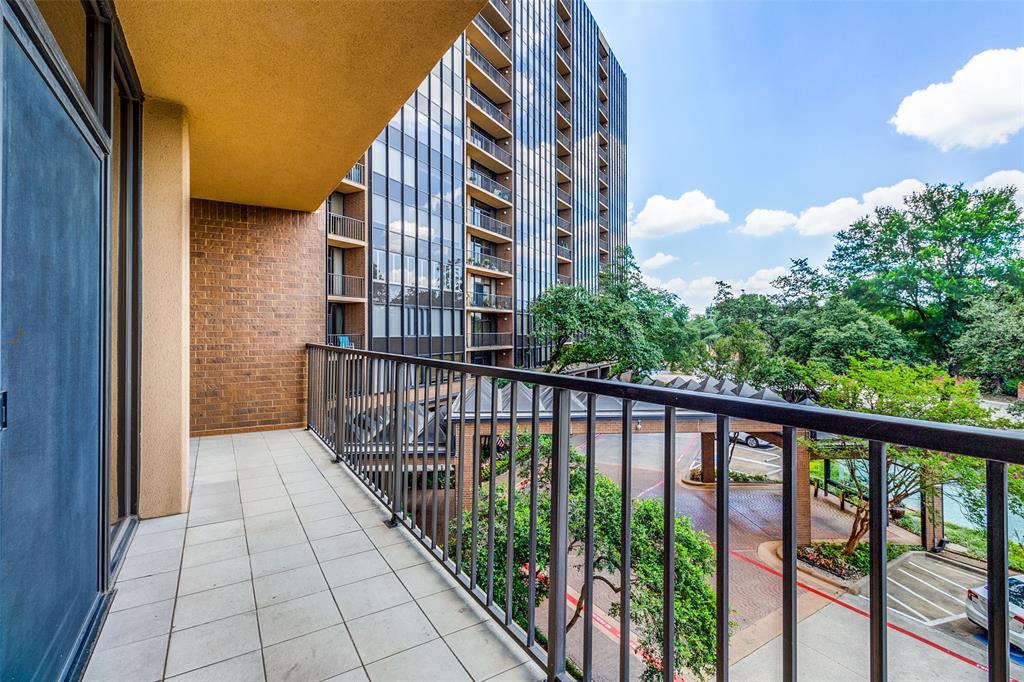 a balcony view with a yard