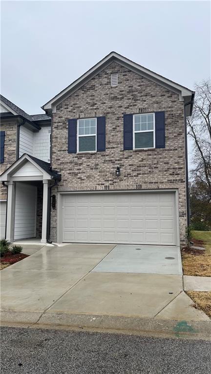 a front view of a house with garage